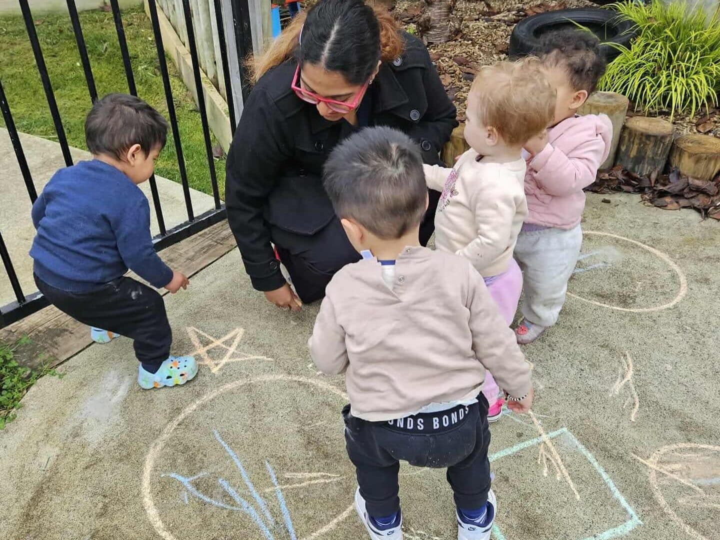 Children playing and learning in a vibrant childcare environment, emphasizing early childhood education blooming buds children playing